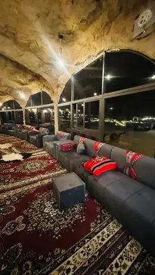 a group of couches in a room with a carpet at NAEL BEDOUIN lUXURY CAMP in Wadi Rum