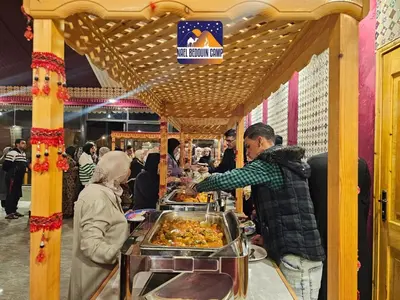 a man serving food at a buffet in a market at NAEL BEDOUIN lUXURY CAMP in Wadi Rum