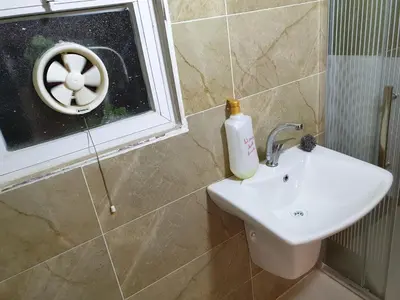a bathroom with a sink and a window at atoom studio in Jerash
