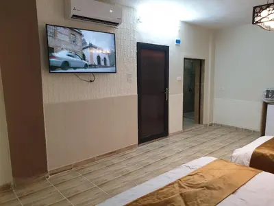 a hotel room with a tv on the wall at atoom studio in Jerash