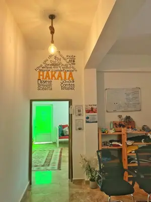 a living room with a table and a chair at Hakaia Community in Aqaba