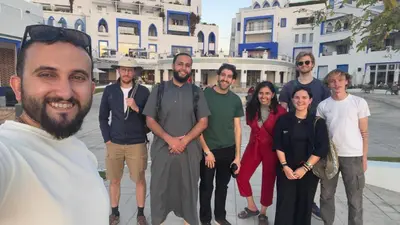 a group of people posing for a picture in front of a building at Hakaia Community in Aqaba