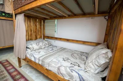 a bedroom with a wooden bunk bed in a room at Hakaia Community in Aqaba