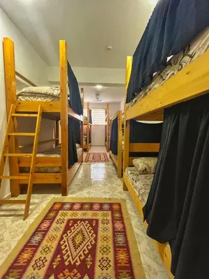 a room with two bunk beds and a rug at Hakaia Community in Aqaba