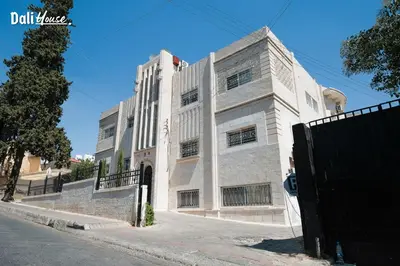 a large white building on a street at Dali House in Amman