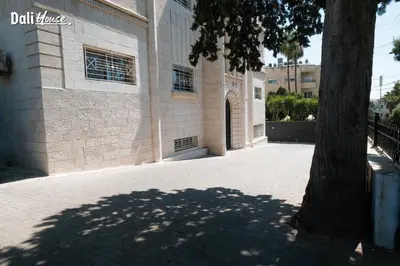 a building with a tree in front of it at Dali House in Amman
