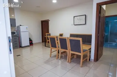a dining room with a table and chairs and a refrigerator at Dali House in Amman