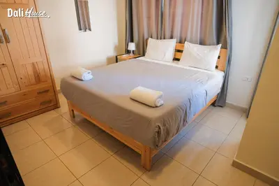 a bedroom with a bed with two towels on it at Dali House in Amman
