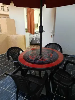 a table with an umbrella on a patio at Al Naser Hotel in Amman