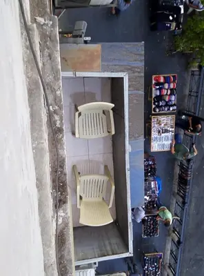 an overhead view of a patio with two white chairs at Al Naser Hotel in Amman