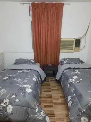 two beds sitting next to each other in a bedroom at Al Naser Hotel in Amman