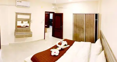a bedroom with a bed with two stuffed animals on it at RAWA'AT ALAQABA in Aqaba