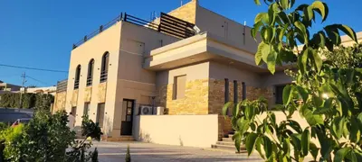 a large white building with a roof at VILLA MARIA PETRA in Wadi Musa