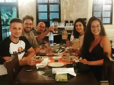 a group of people sitting around a dinner table at Mount Nebo Hotel & Restaurant Madaba City Center in Madaba