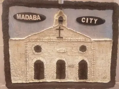 a model of a church with a street sign at Mount Nebo Hotel & Restaurant Madaba City Center in Madaba