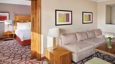 a living room with a couch and a bed at InterContinental Amman Jordan by IHG in Amman