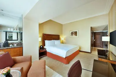 a hotel room with a bed and a living room at InterContinental Amman Jordan by IHG in Amman