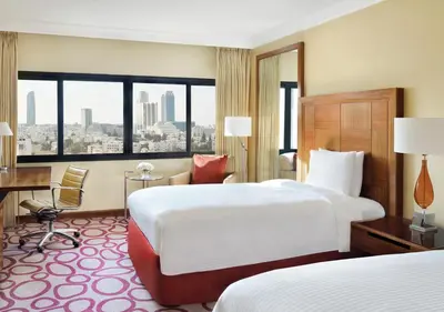 a hotel room with two beds and a desk at InterContinental Amman Jordan by IHG in Amman