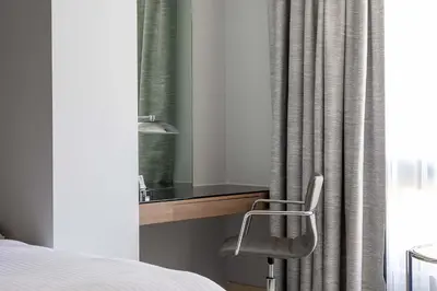 a bedroom with a desk and a chair next to a window at InterContinental Amman Jordan by IHG in Amman