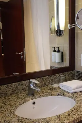 a bathroom counter with a sink and a mirror at InterContinental Aqaba by IHG in Aqaba
