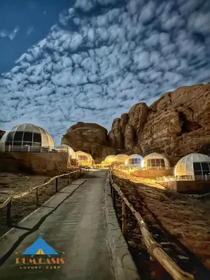 a dirt road in a desert with many domes at Rum Oasis Luxury Camp in Wadi Rum