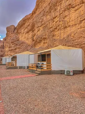a building in front of a mountain at Rum Oasis Luxury Camp in Wadi Rum