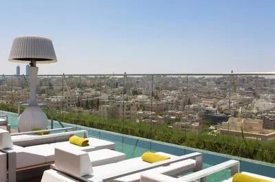 a living room with a view of a city at Regency Palace Amman in Amman