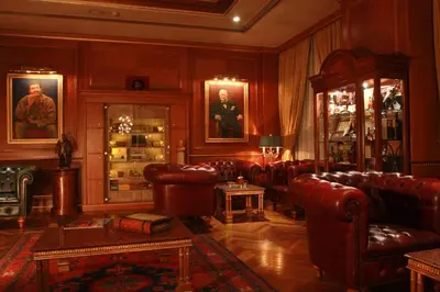 a living room with leather couches and a table at Regency Palace Amman in Amman