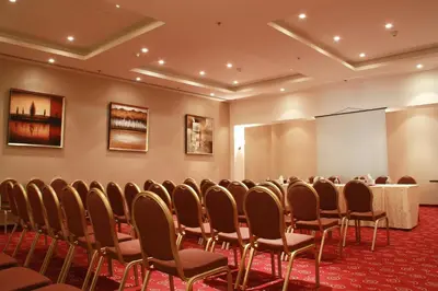 a conference room with a table and chairs at Regency Palace Amman in Amman