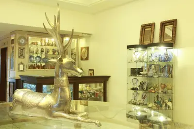 a gold statue of a deer sitting on a glass table at Grand Palace Hotel in Amman