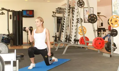a woman doing a yoga pose in a gym at Grand Palace Hotel in Amman