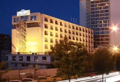 a building with a sign on the side of it at Grand Palace Hotel in Amman