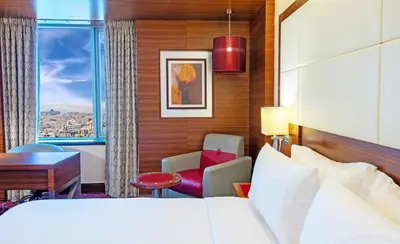 a hotel room with a bed and a desk at Crowne Plaza Amman by IHG in Amman