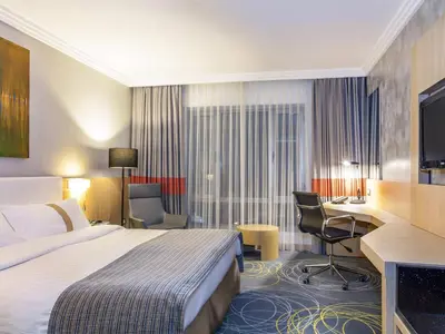 a hotel room with a bed and a desk at Mövenpick Hotel Amman in Amman