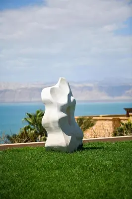 a white sculpture sitting on top of a field of grass at Kempinski Hotel Ishtar Dead Sea in Sowayma
