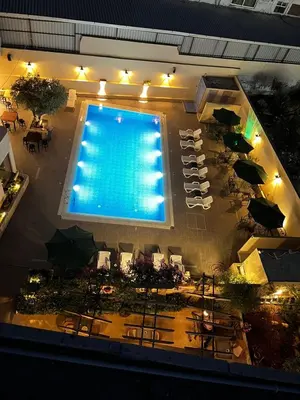 an overhead view of a swimming pool with tables and chairs at Salome Hotel in Madaba