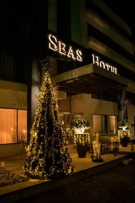 a christmas tree in front of a building at Seas Hotel Amman in Amman