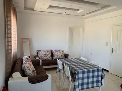 a living room with a couch and a table at Gedara Guesthouse: enjoy unforgettable scenes in Um Qeis