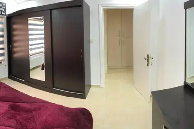 a living room with a large mirror and a red couch at Apt 4 rent/A quiet neighborhood close to services in Amman