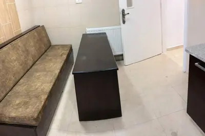 a brown couch in a room with a door at Apt 4 rent/A quiet neighborhood close to services in Amman
