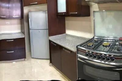 a kitchen with a stove and a refrigerator at Apt 4 rent/A quiet neighborhood close to services in Amman