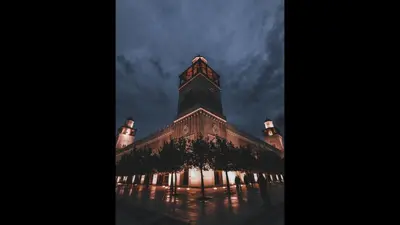 a large building with a clock tower at night at Superior Executive Apartment in Umm Uthainah