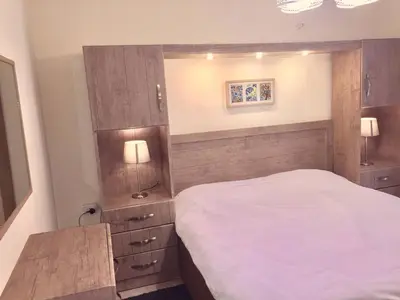 a small bedroom with a bed and two lamps at The Royal Luxury King Terrace 1 in Amman