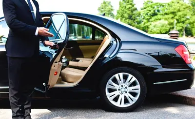 a man in a suit getting into a car at The Royal Luxury King Terrace 1 in Amman