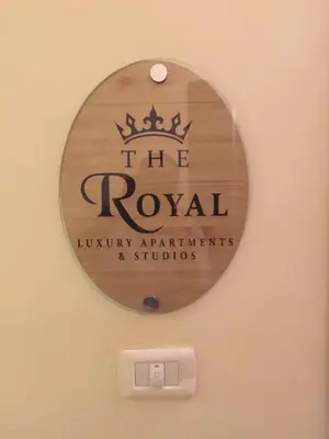 a sign on a wall that reads the royal luxury apartmentitals at The Royal Luxury Superior King in Amman