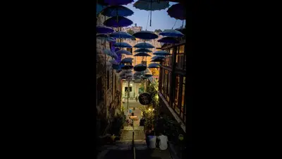 a group of blue umbrellas hanging from a building at The Royal Luxury City Budget Visit in Amman