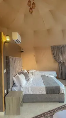 a bedroom with two beds in a room at Wadi Rum Relaxation Camp in Wadi Rum