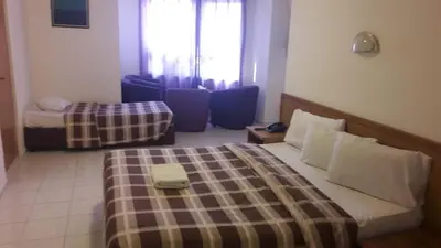 a hotel room with a bed and a window at Razan Hotel in Amman