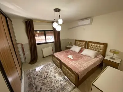 a bedroom with a bed and a window at ROYAL Real ESTATE in Amman