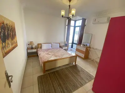 a bedroom with a bed in a room with a window at ROYAL Real ESTATE in Amman